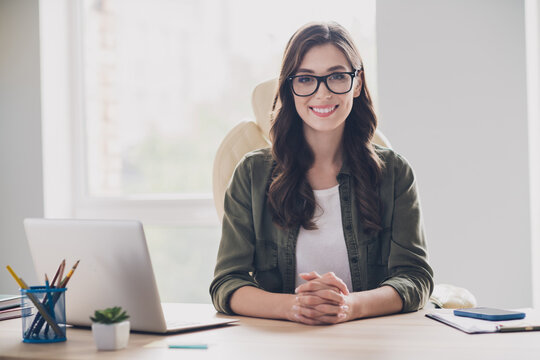 Photo of happy smiling lady assistant wear glasses welcoming you new company indoors workstation workshop