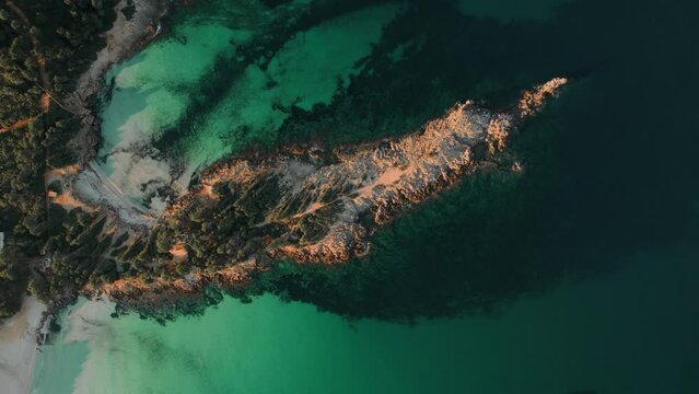 Picturesque drone point of view Cala Agulla is a beautiful beach in Majorca. Aerial shot green Mediterranean Sea at sunny day. Spain. Balearic Islands