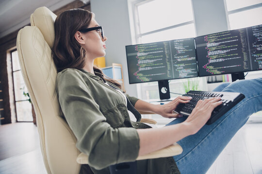 Photo of intelligent cool lady programmer wear spectacles coding new application indoors workplace workshop