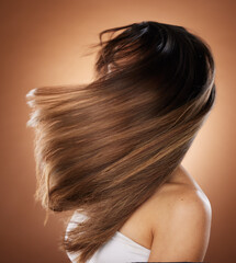 Beauty, hair and salon with a model woman in studio on a brown background for keratin haircare treatment. Health, luxury and hair care with a young female posing to promote a natural hairstyle - obrazy, fototapety, plakaty