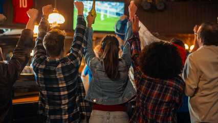 Group of Friends Watching a Live Soccer Match on TV in a Sports Bar. Excited Fans Cheering and Shouting. Young People Celebrating When Team Scores a Goal and Wins the Football World Cup.