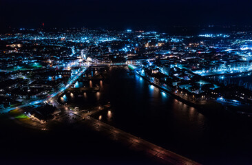 Fototapeta na wymiar Aerial view of Galway city at night. Shot taken at the exit of the Corrib river.