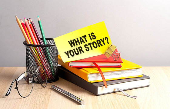 WHAT IS YOUR STORY written on a sticky on notebooks
