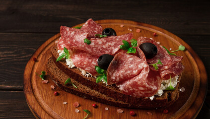 Sandwich , grain bread, with cream cheese and salami, black olives, micro-greens, top view, close-up, no people, Breakfast,