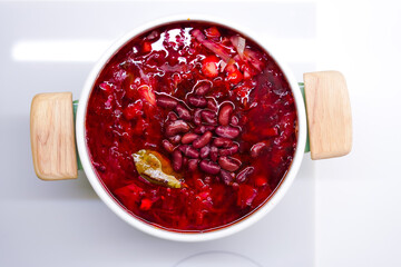 A big beautiful pot of fresh Ukrainian vegan borscht with beans, close-up