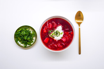 Borscht with sour cream and herbs on a light background, top view