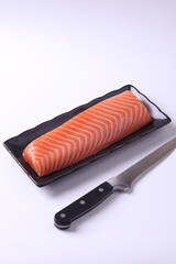 
Salmon sashimi on a wooden chopping board, white background