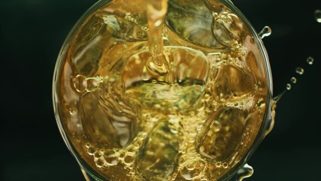 Slow Motion Rotate Turn Ice Cubes Liquid Alcohol. Super Slow Motion 1000 Fps Top View On Pour Whiskey Or Rum On Ice Cubes In Rotate Glass.Slow Motion Pour Whiskey On Spin Ice Cubes In Twist Cup Drink