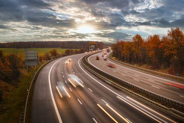 Langzeitbelichtung - Autobahn - Strasse - Traffic - Travel - Background - Line - Ecology - Highway - Night Traffic - Long Exposure - Cars Speeding - Lights - Sunset - High quality photo	
 - obrazy, fototapety, plakaty