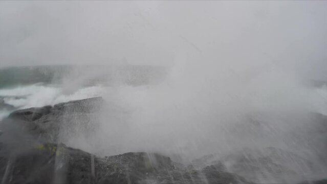 Slow motion shot of a wave breaking on the shore of Lake Superior.  Shot in 60fps and slowed down.  Shot in 4K 60fps