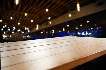 brown wooden board on blurred cafe bokeh background