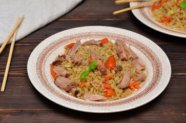 appetizing still life with chinese rice with meat on the table closeup