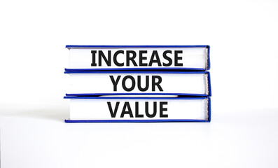 Increase your value symbol. Concept words Increase your value on books on a beautiful white table white background. Business increase your value concept. Copy space.