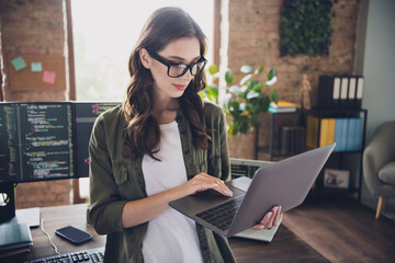 Photo of successful web designer lady use modern gadget macbook typing sms message chatting clients...