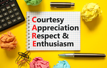 CARE symbol. Concept words CARE courtesy appreciation respect and enthusiasm on white note on beautiful yellow background. Business CARE courtesy appreciation respect enthusiasm concept. Copy space.