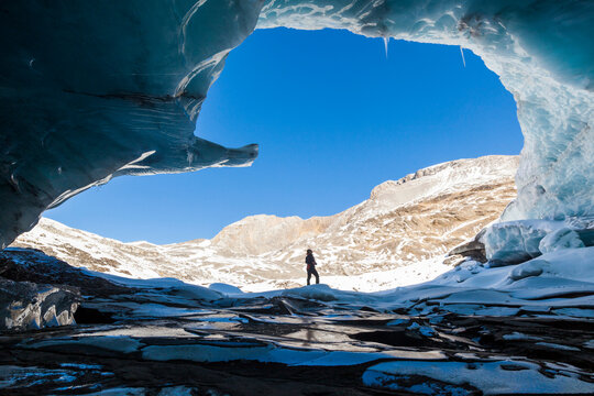 Woman entering ice cave at Plaine Morte Glacier, Canton of Bern, Switzerland