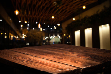 empty wooden brown table on blurred light gold bokeh cafe restaurant bar, place for your products...