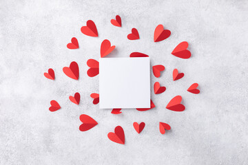 Valentine day composition with paper card and various red hearts for love romantic message. Flat lay style..