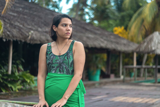 Woman poses in front of a tourist camp, while staring at the horizon