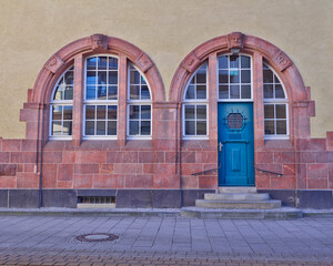 A beautiful double arch entrance with a blue door and windows. Travel to Sachsen, Germany.