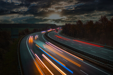 Fototapeta na wymiar Langzeitbelichtung - Autobahn - Strasse - Traffic - Travel - Background - Line - Ecology - Highway - Night Traffic - Long Exposure - Cars Speeding - Lights - Sunset - Light Trails - High quality 