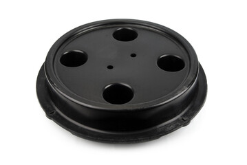 Black plastic manhole cover on a white