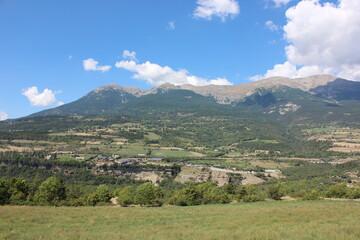 Alpine landscape in the Hautes-Alpes with on the mountains and sky.