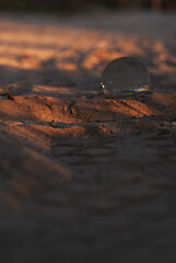 View on lens in a sand in sunset light