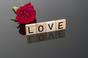 Love message with rose on dark background