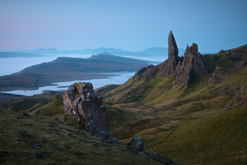 Atmospheric view from above of the tall, sharp cliffs overlooking the lake and the sea. The Old Man of Storr, The Isle of Skye, Scotland, UK