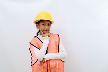 Cute Asian little girl in the construction helmet as an engineer standing confidently looking at the camera. Isolated on white