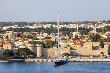 Obraz premium Sailboat near Historic Old Town in City on the Mediterranean Sea, Rhodes, Greece.