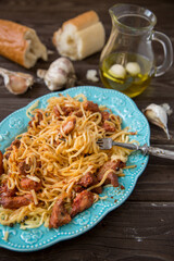 Italian food in rustic style. Spaghetti bolognese on a dark wood table.