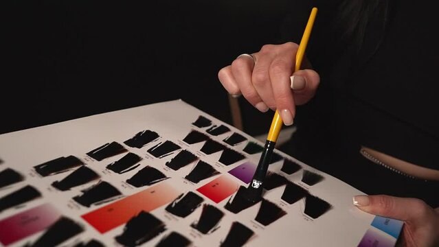 in the catalog with hair samples, everything is dyed black. close-up. High quality Full HD video recording
