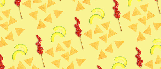 Tasty nachos with avocado slices and salsa sauce on light yellow background
