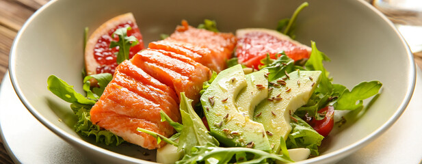 Bowl with fresh salad and salmon, closeup. Diet concept