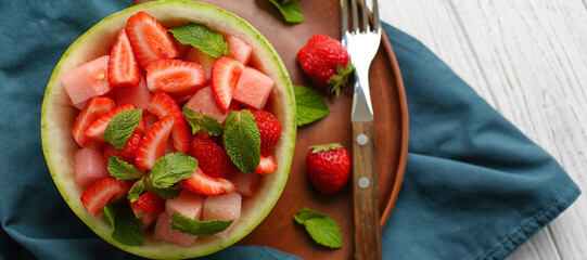 Delicious fruit salad in melon bowl on table. Diet concept