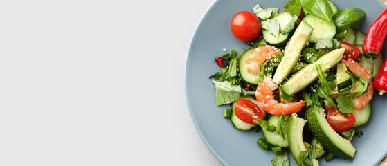 Salad with avocado and shrimps on plate against light background with space for text. Diet concept