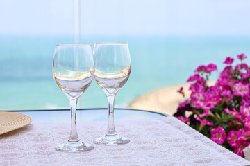 Table with wine glasses on balcony, closeup