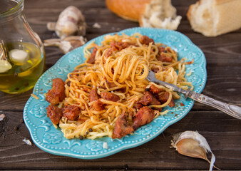 Italian food in rustic style. Spaghetti bolognese on a dark wood table.