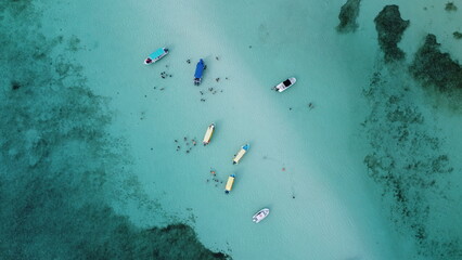Tourists rest near speedboats parked on the El Cielo sandbar. Cozumel, Mexico	
