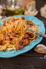 Italian food in rustic style. Spaghetti bolognese on a dark wood table.