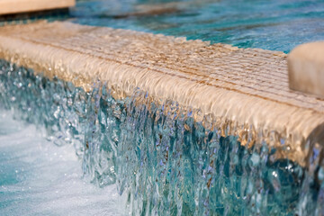 Fountain with running water in city, closeup