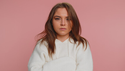 Woman in white sweater screams yell from stress tension problems feels horror hopelessness fear panic surprise shock expresses gestures rage. Young pretty girl isolated on pink studio background