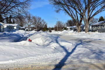 Snow piled up along streets and on properties in Bismarck, ND following a very snowy December.