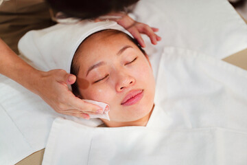 Relaxed woman enjoying facial treatment