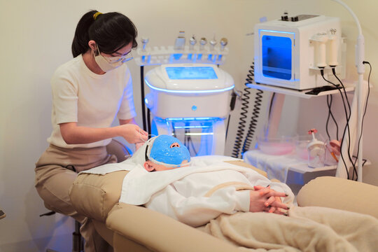 Beautician applying alginate mask