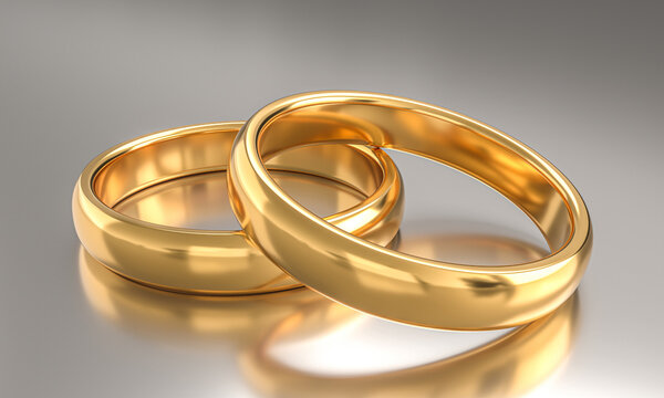 gold wedding rings on metal top.