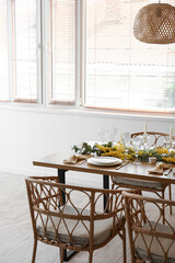 Beautiful table setting with mimosa flowers and candles in room