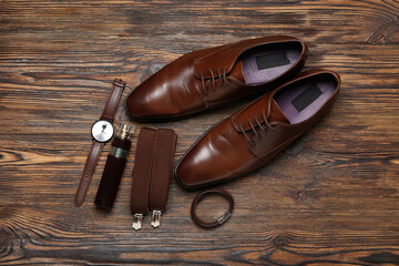 Male shoes and stylish accessories on wooden background